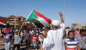 An elderly Sudanese man flashes the victory sign as protesters rally to call for a return to civilian rule in the capital Khartoum, on November 21, 2021. (Photo by AFP) (Photo by -/AFP via Getty Images)